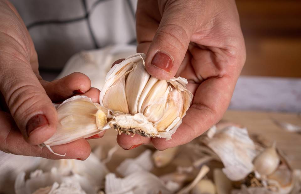 My mother-in-law taught me a wonderful way to peel garlic.  She took the beer cap and things started happening