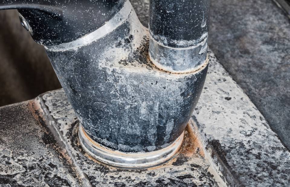 Hardened limestone literally disappears in 5 minutes.  People in the West use a genius trick